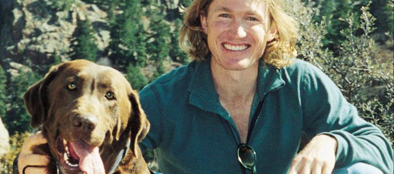 Patrick smiling with his dog, Zuke